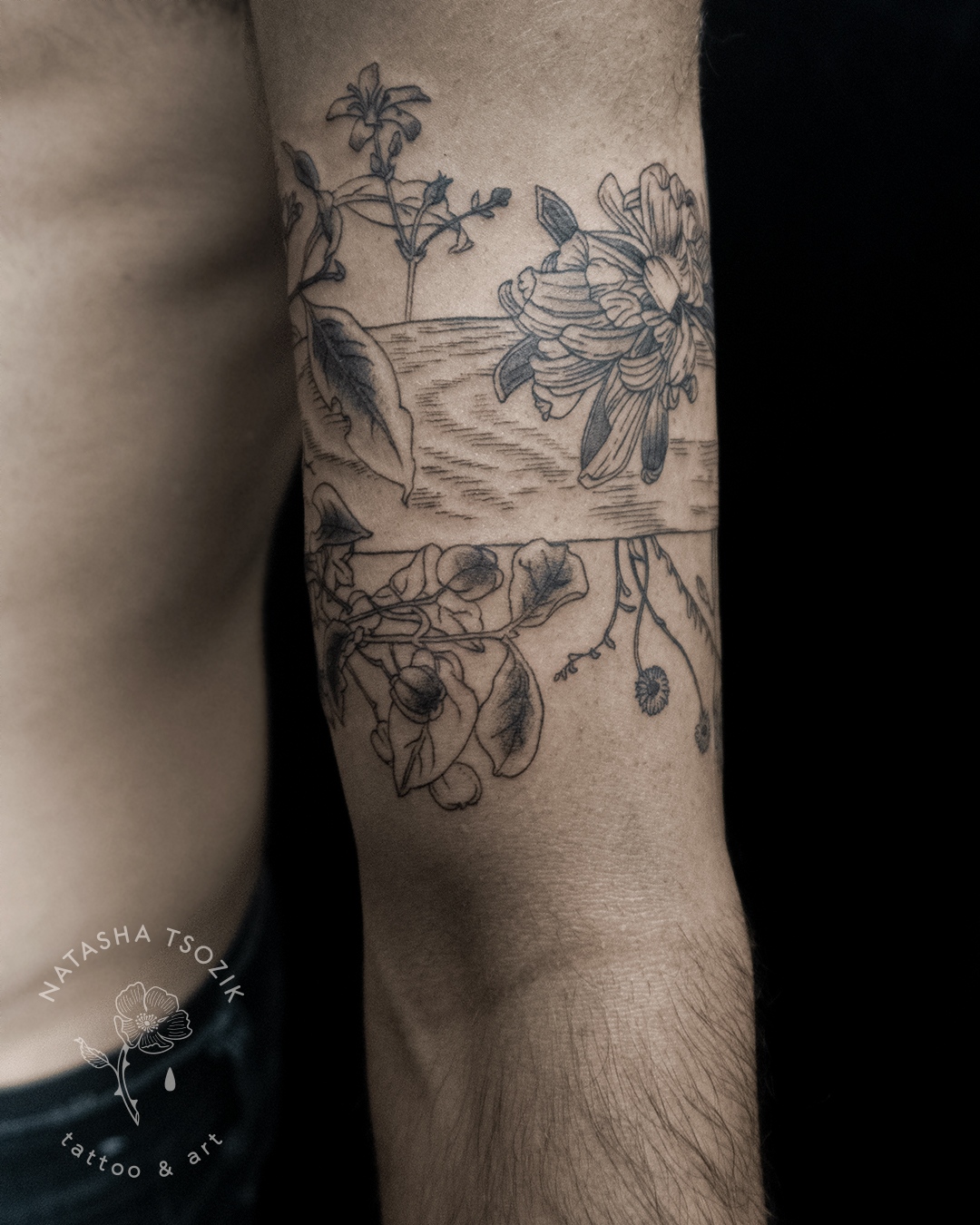 Flower armband tattoo on the right forearm