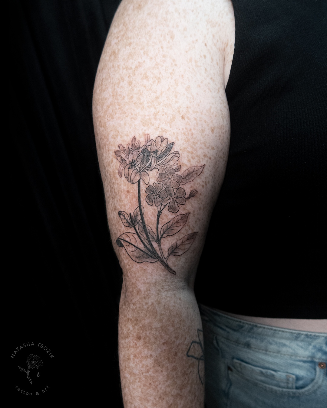 Friendship – floral tattoo on an arm with freckles
