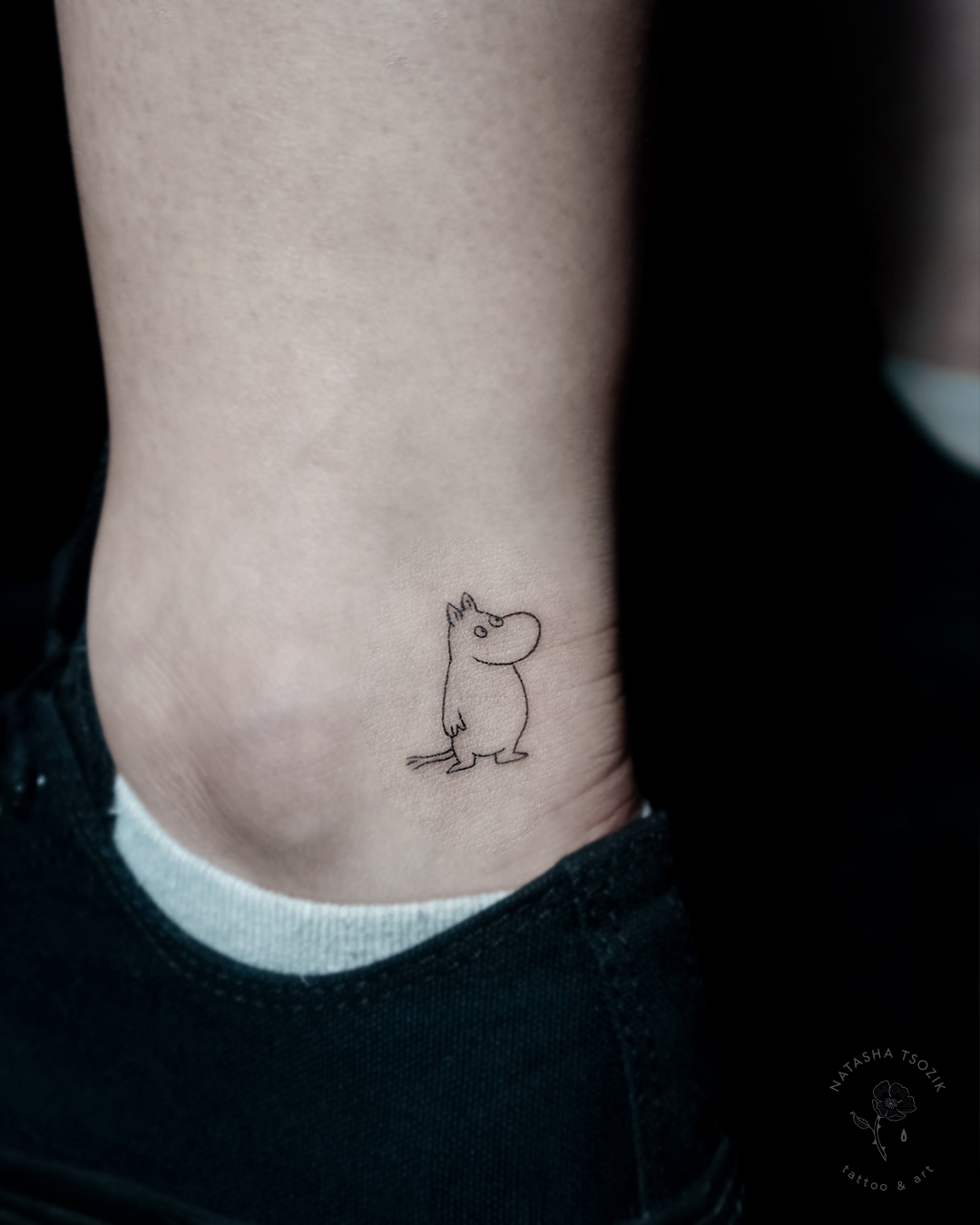 Small Moomin tattoo on ankle.