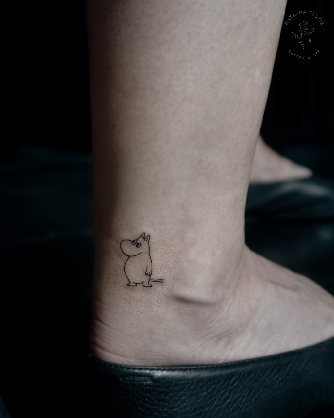 Small matching Moomin tattoo on ankle.