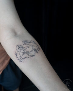 Fineline pet tattoo on a forearm.