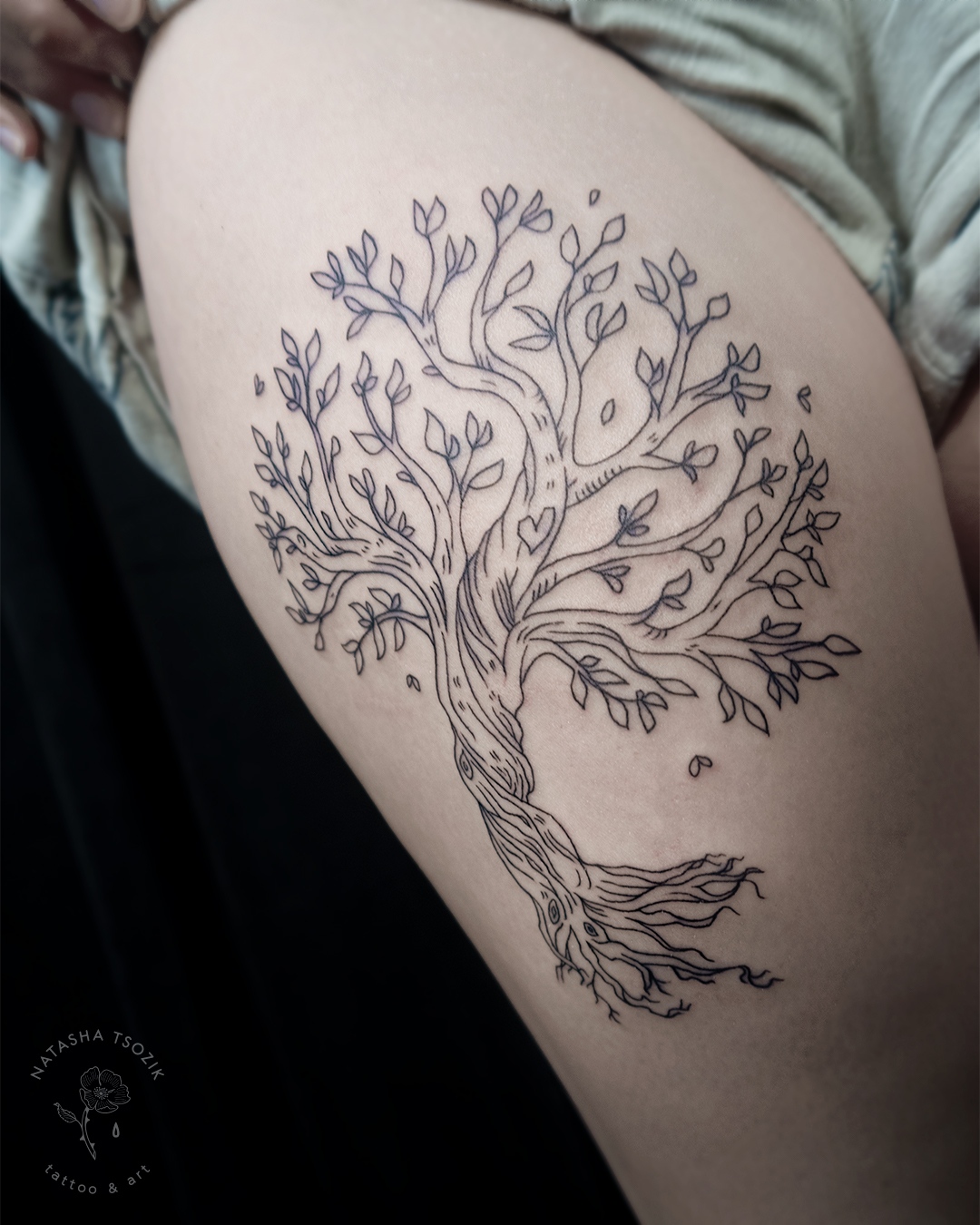 Fine line tree tattoo on a hip.