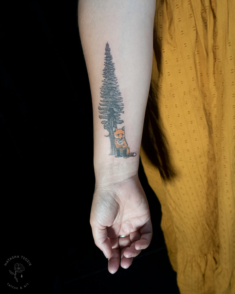Redwood with a fox tattoo on a forearm