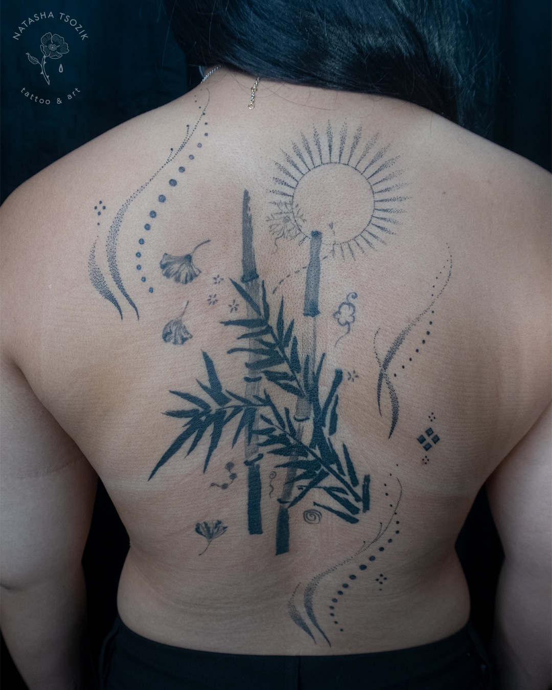 Healed bamboo tattoo on a back.