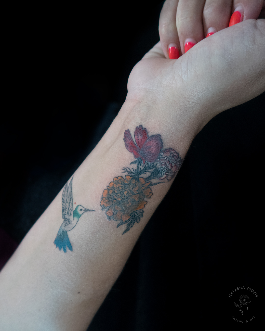 Healed floral tattoo with a humming bird on a wrist.