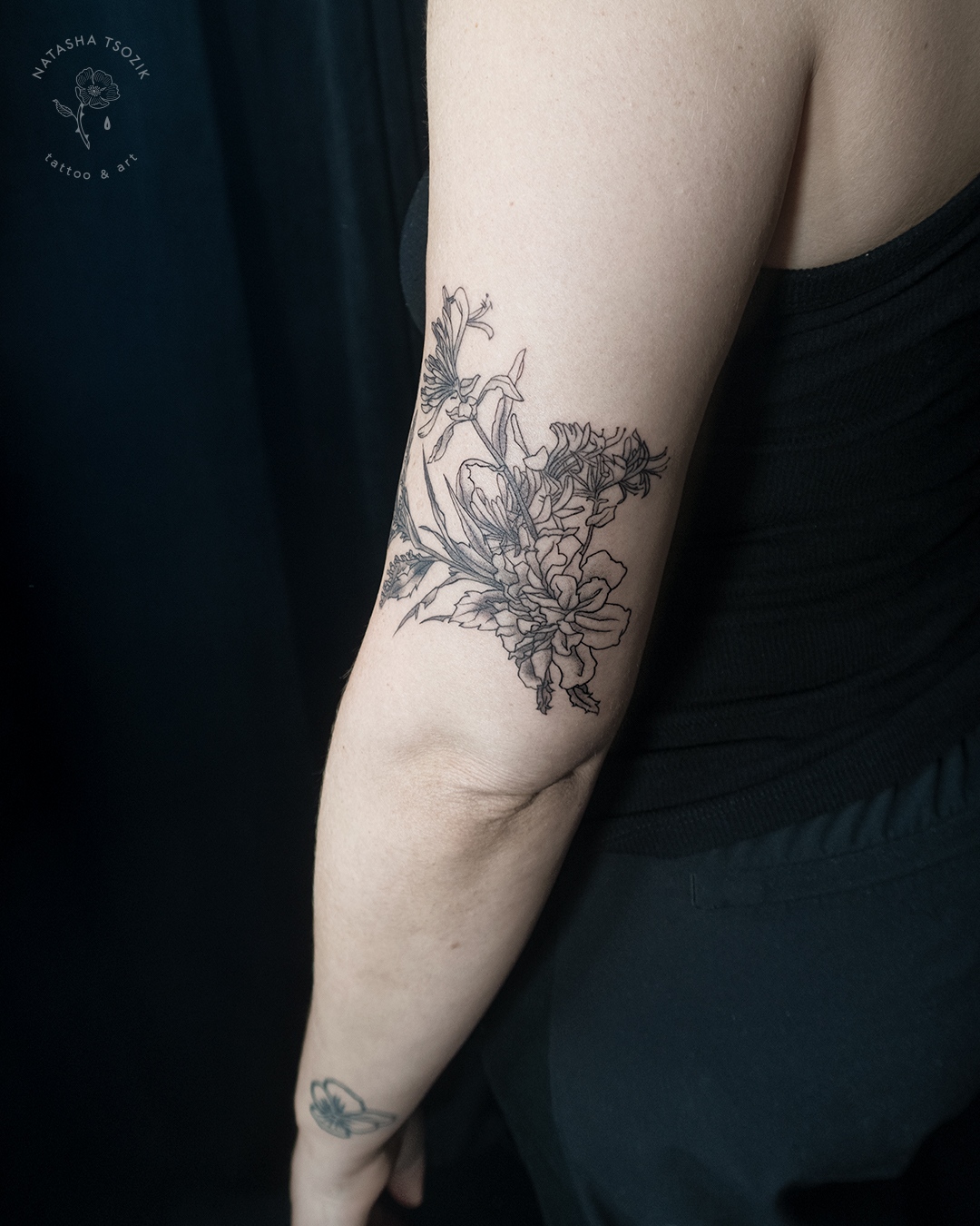 Botanical tattoo on a bicep. A floral bouquet with the moon above it.