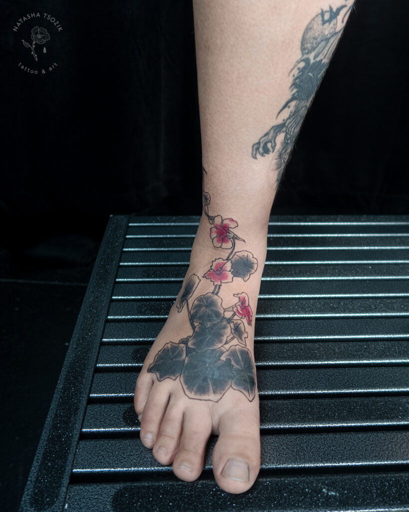 Side-view of Nasturtium tattoo on a feet.