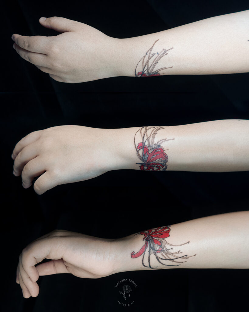 Spider Lilly floral bracelet tattoo on a wrist.