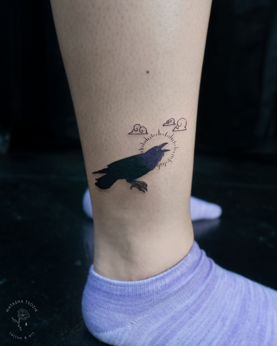 Yokai raven tattoo on an ankle.