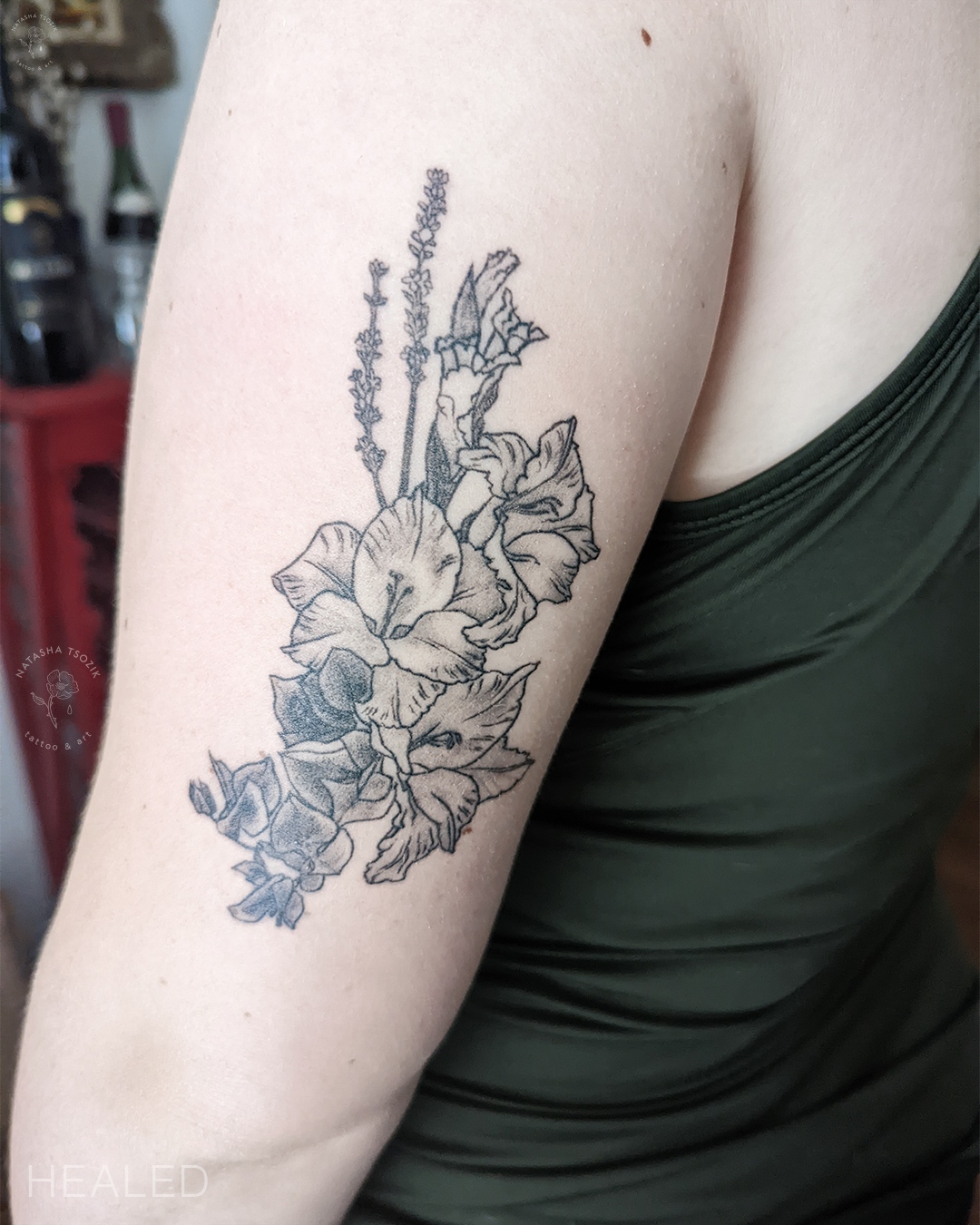 A floral bouquet tattoo on a bicep.