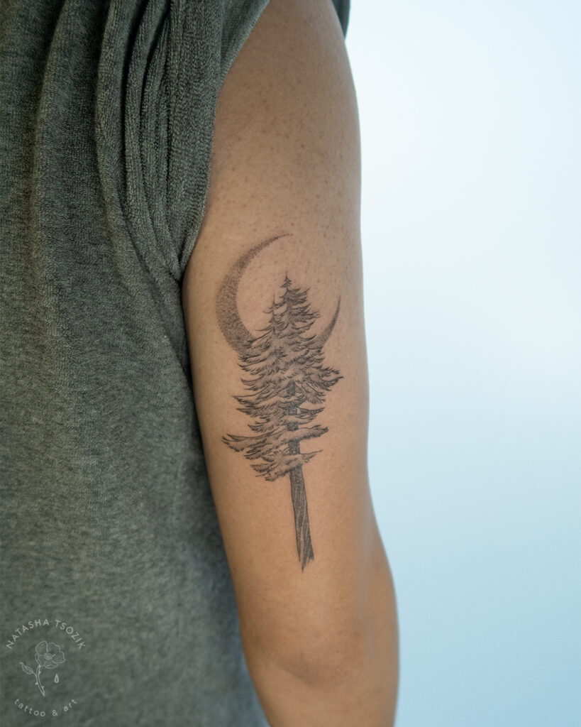 Redwood tattoo with a moon on a bicep