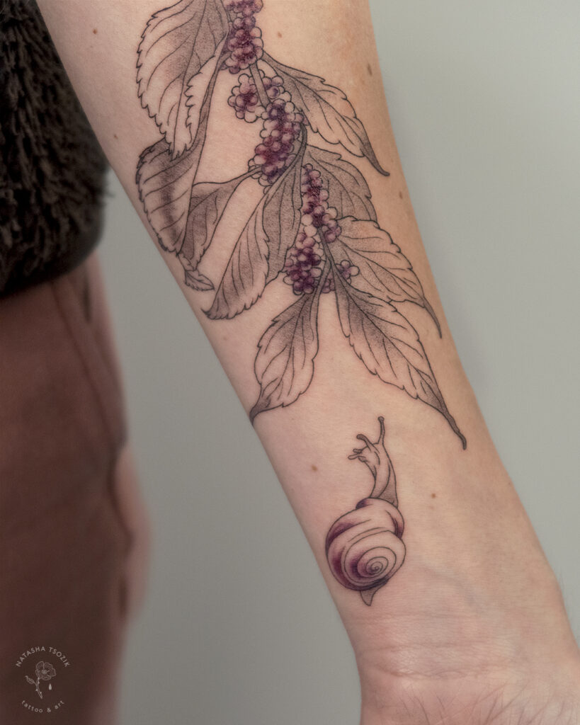 Beautyberry tattoo on a forearm.