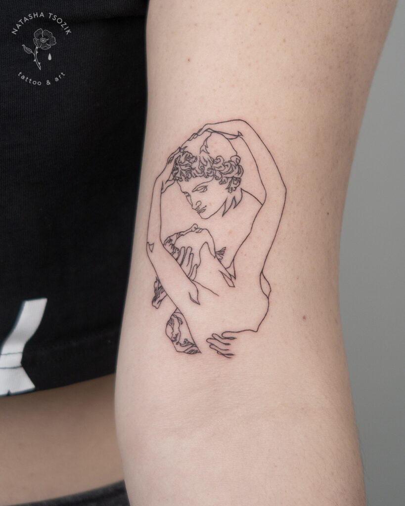 Line tattoo on a bicep by Natasha Tsozik.