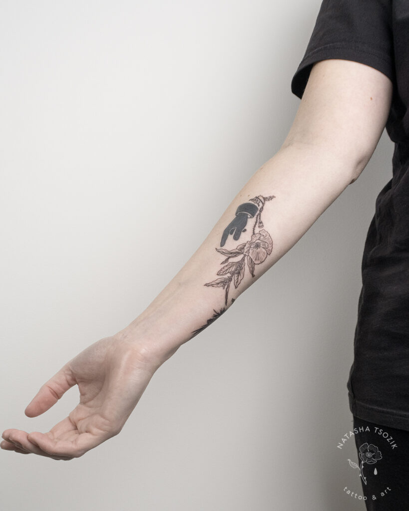 Floral tattoo on a forearm by Natasha Tsozik.