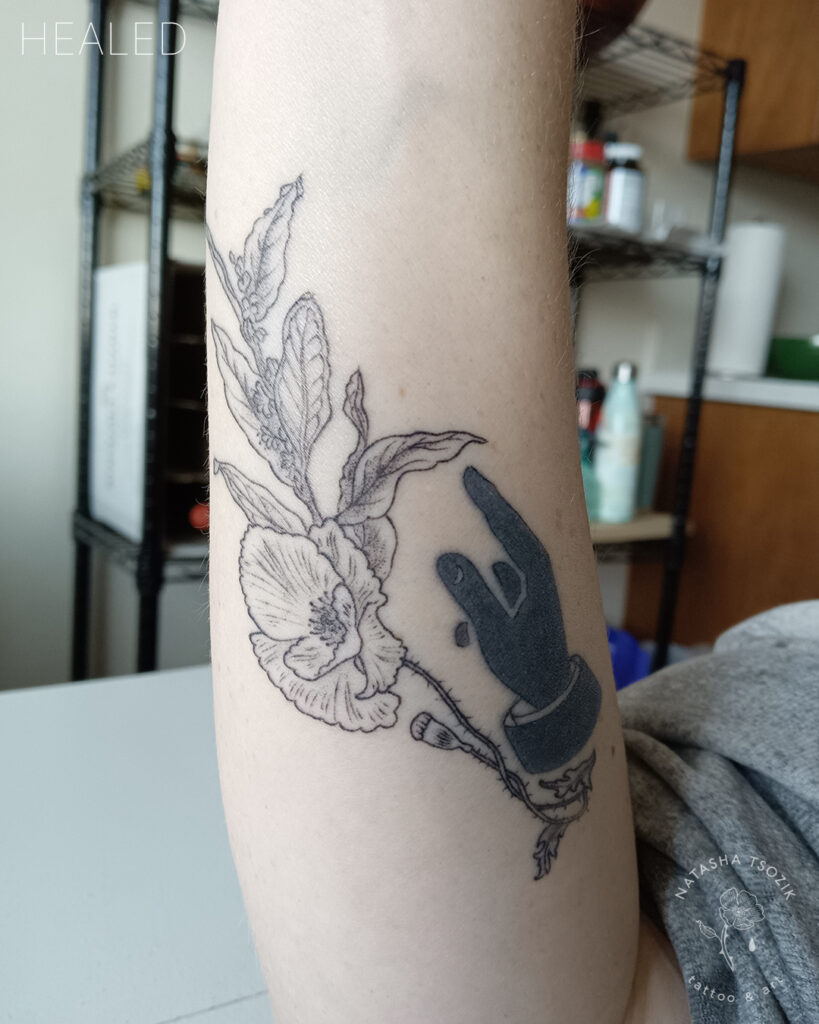 Healed floral tattoo on a forearm by Natasha Tsozik.